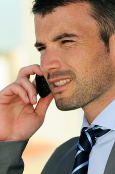businessman is having a communication with his cellphone