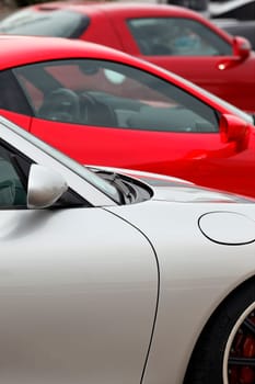 three sport cars in a garage for sale