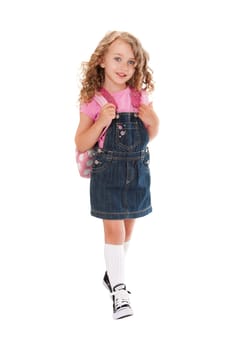 Happy preschooler with backpack walking to school in the spring or summer, isolated.