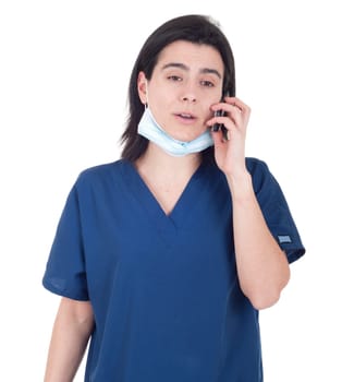 concerned female doctor in uniform talking on the phone (isolated on white background)