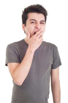 exhausted young man yawning isolated on white background