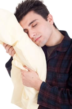 happy young man in pajamas holding pillow isolated on white background