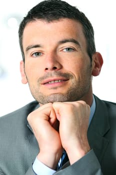 An attractive business man in a light business environment