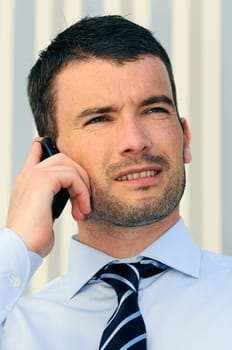 businessman is having a communication with his cellphone
