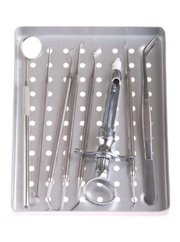 dentistry kit in a metal tray (surgery instruments and syringe) isolated on white background