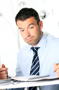 busy man hiding behind a stack of files