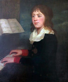 William Crotch, famous musician, composer, organist and artist. First Principal of the Royal Academy of Music, London, England is shown playing the piano when he was about 12 years old in this oil painting. He is wearing a black coat with red cuffs, gold