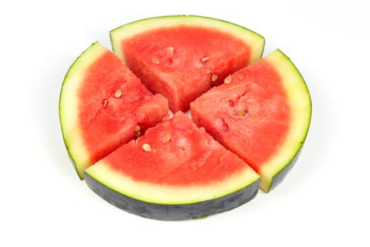 One whole organic watermelon slice cut into four pieces on white background.