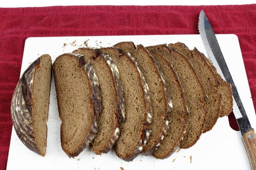 Several pieces are cut from a loaf on a cutting board.