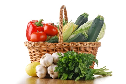 Composition with raw vegetables and wicker basket