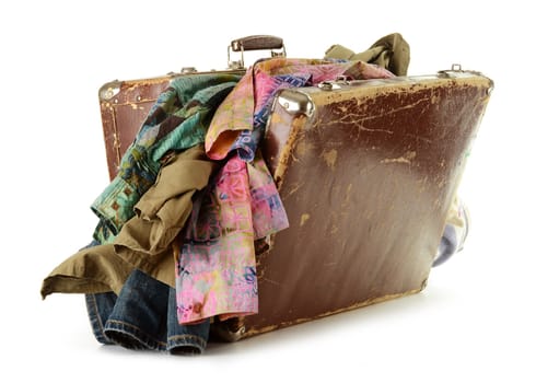Old suitcase with clothes inside isolated on white