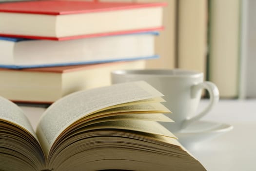 Composition with books and cup of coffee on the table