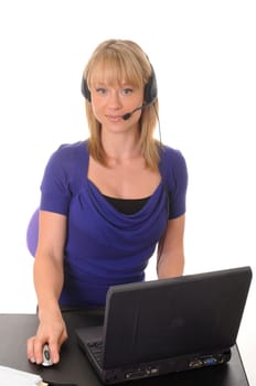 Young businesswoman wearing a headset and working on a laptop