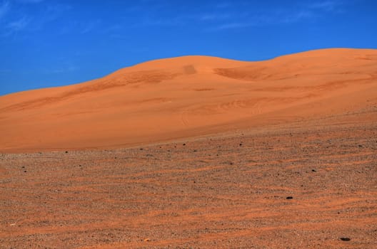 Sand dunes with brillaint blue sky