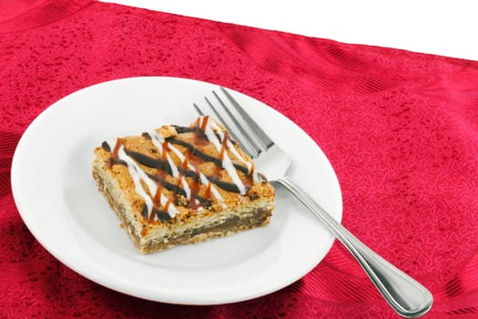 A rich and gooey sweet treat made from coconut, pecans, almonds.