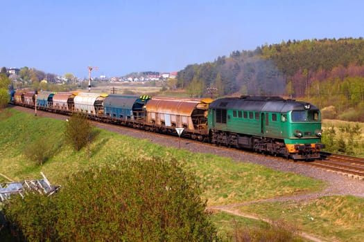 Freight train passing the hilly landscape