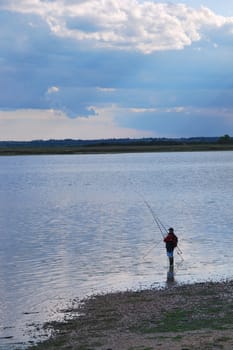 Angler in solitude on creek