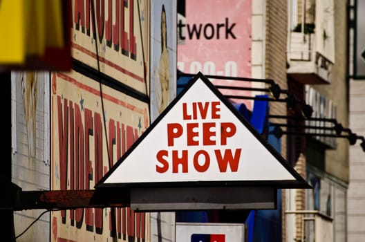 a street sign advertising a peep show