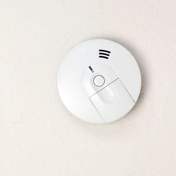 Small round battery operated device to warn residents of fire.