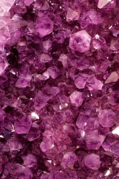 Background of amethyst quartz crystal precious stones in a natural formation.