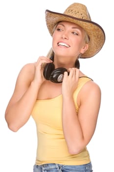 Studio shot of a young woman wearing a straw hat and headphones