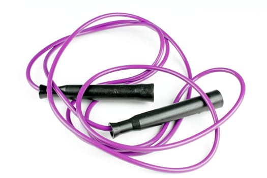 Purple jump rope tossed onto a white background after exercising.