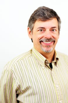 Mature male looking at camera with an open smile showing teeth, happy and confident.