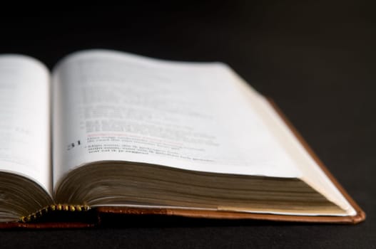 Closeup of a Dutch Bible on a black background