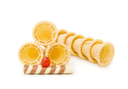 Empty ice cream cones with chocolate waffle and red cherry. Isolated over white background.