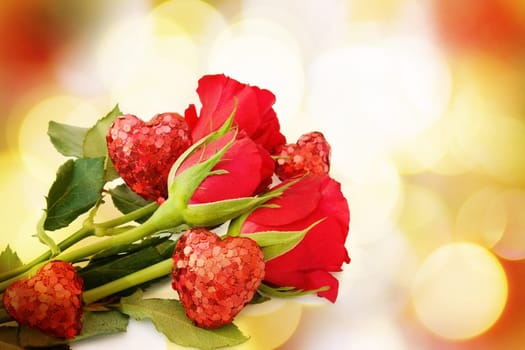 Love greeting card with red roses and hearts over defocused, festive lights.