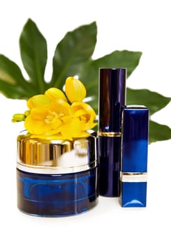 Luxury face cream and make up in blue. Isolated over white.