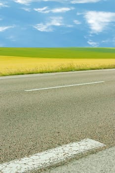 Landscape with road, fields and sky