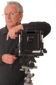 Senior photographer with a large format camera on tripod