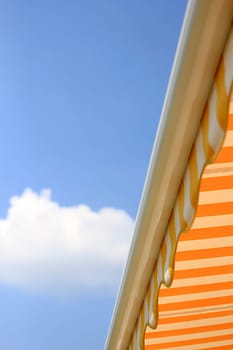 Yellow sun awning in front of blue sky