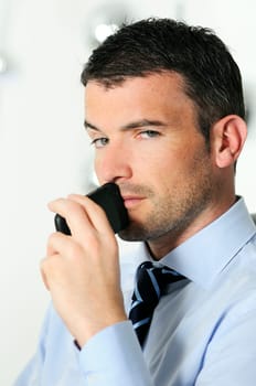 businessman is having a communication with his cellphone