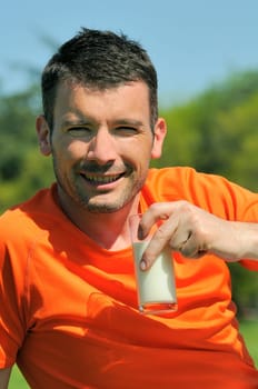 man is drinking fresh glass of milk in the natural background