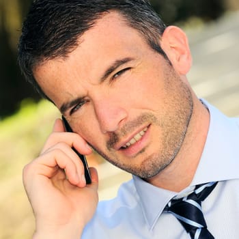businessman is having a communication with his cellphone