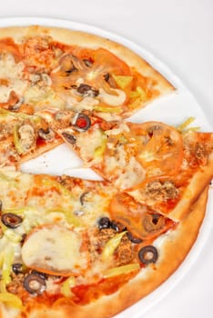 seafood pizza closeup with salmon, shrimps, tomato, pepper, olive and mozzarella cheese on a white background