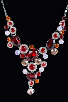 pendant closeup with big gem at black background