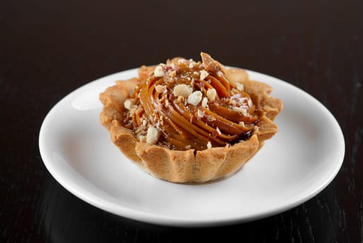 fresh baked cupcake with nuts on a wooden table