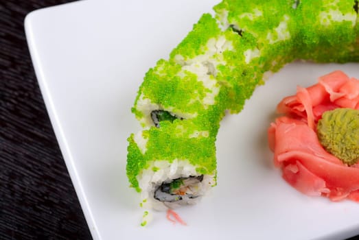 Sushi rolls made of salmon, avocado, flying fish roe - tobiko caviar and philadelphia cheese