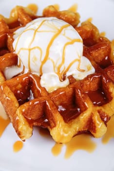 Tasty waffle and ice cream with cream