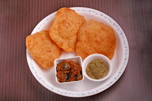 Indian deep-fried bread - poori with chutney and subzi