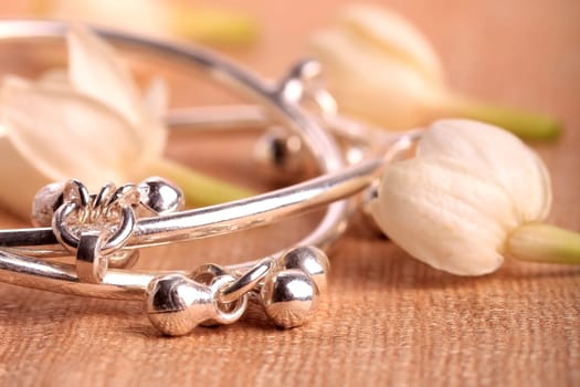 Child leg bracelet closeup with jasmine flowers