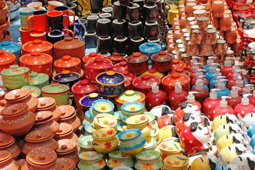 Colorful ceramic pots and utensils displayed for sale