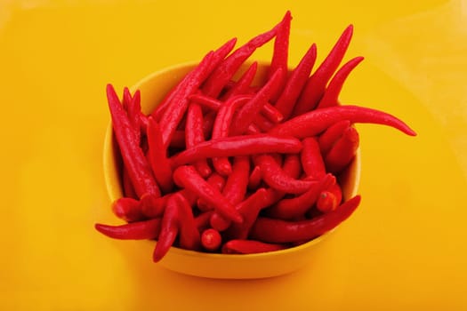 Bunch of cayenne peppers in a yellow bowl