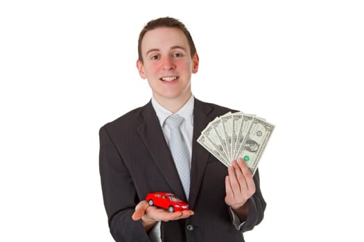 Friendly businessman with model car and dollar bills