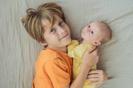 A young boy and his newborn brother lie together on a soft muslin blanket, sharing a tender sibling moment. A heartwarming scene of brotherly love, bonding, and the beginning of a lifelong connection.