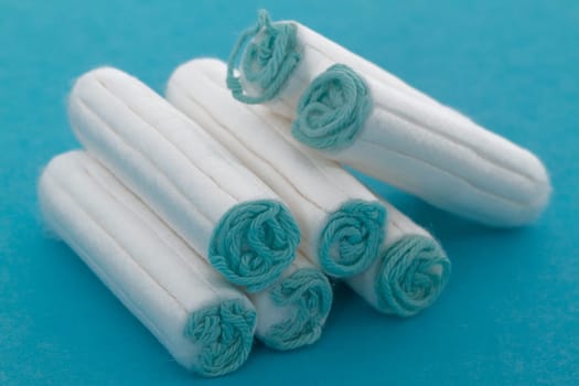Women's tampons on light blue background