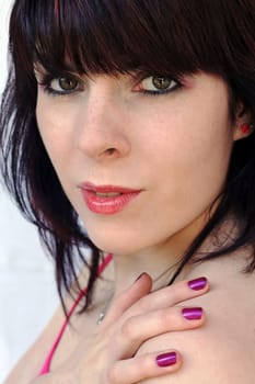 Pink lipstick and purple nail polish